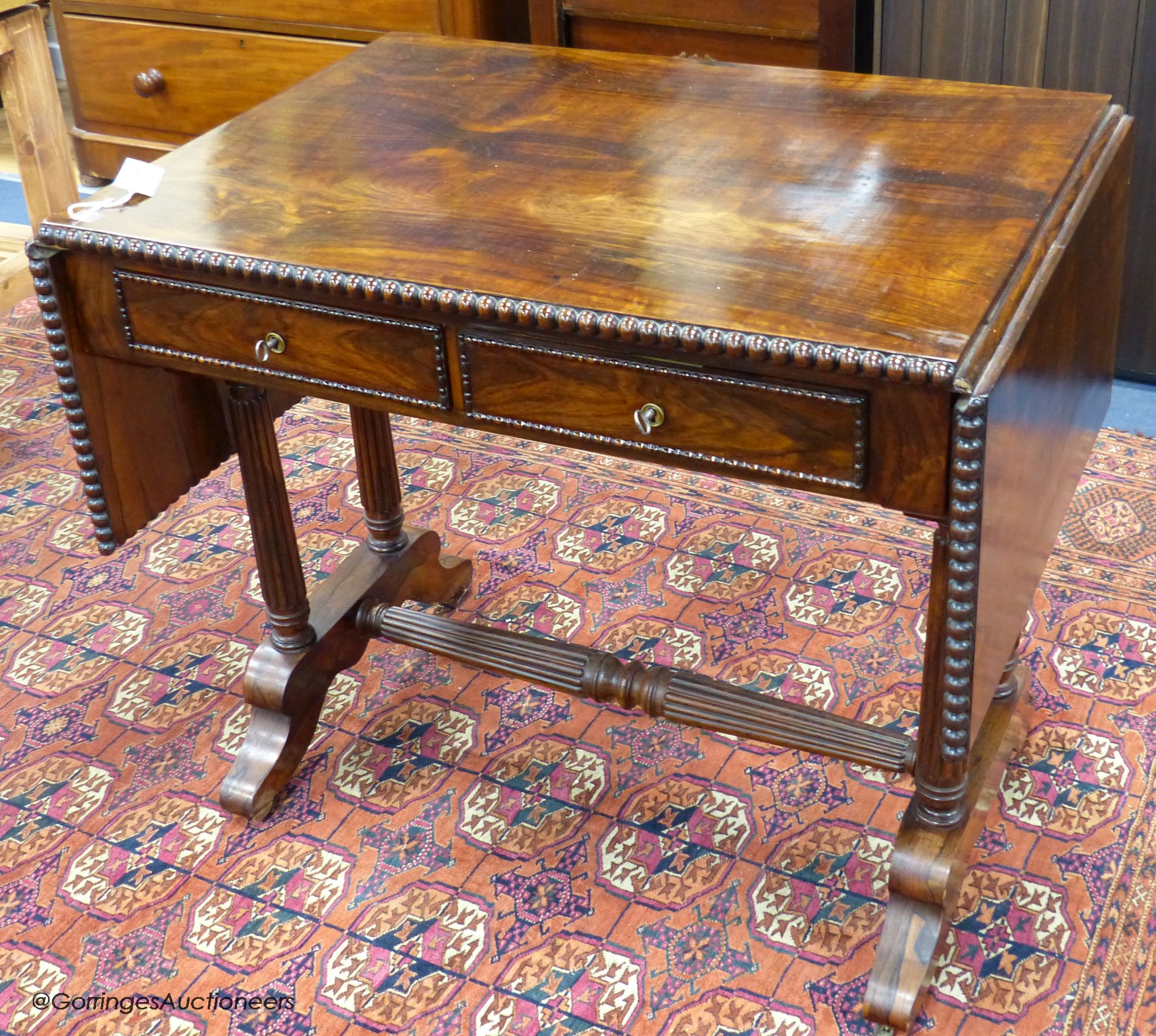 A 19th-century French rosewood sofa table, 86 cm wide with the leaves down, 61.5 cm deep, 75 cm high